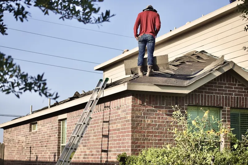 Professional roofer working on a residential roof in DeKalb